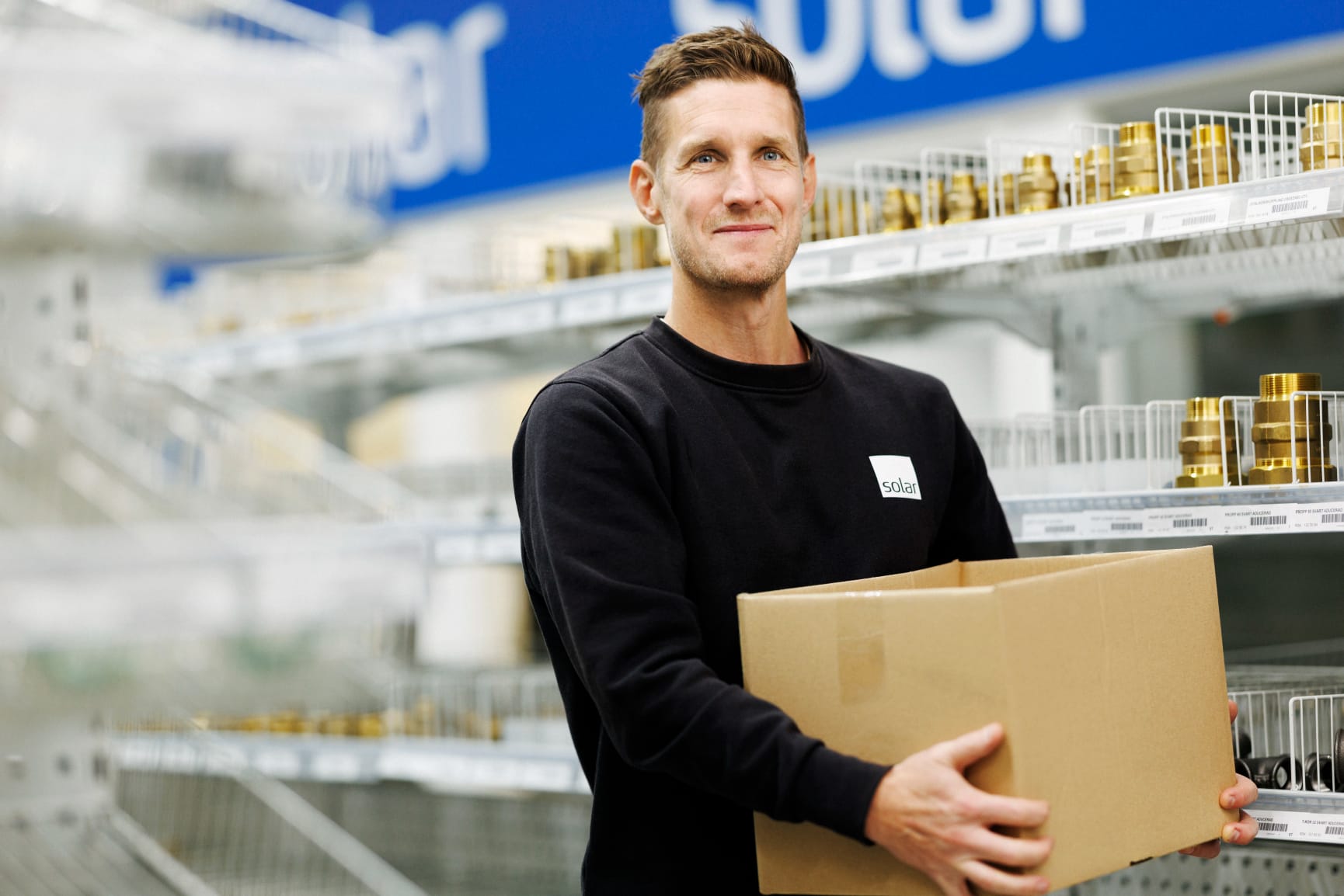 Man carrying boxes at a shop or drive-in